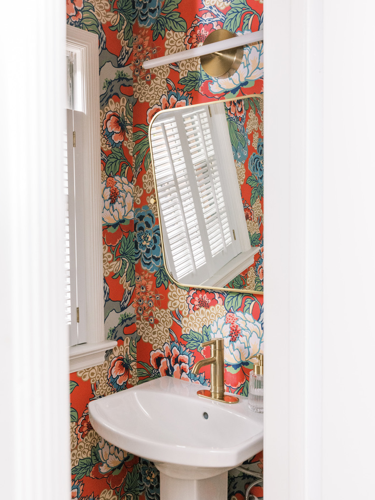 Red vibrant powder room with pedestal sink. 