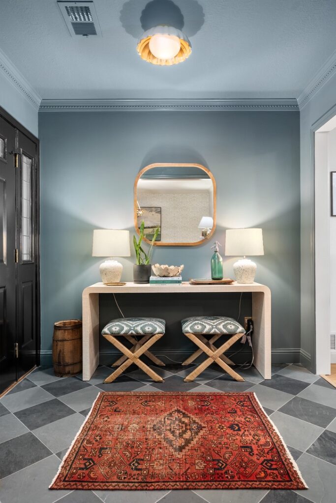 Entryway design with statement lighting, layered textures, and a styled console table